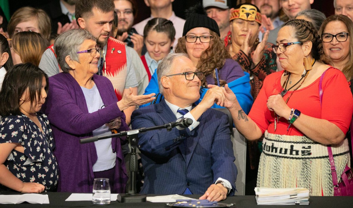 Gov. Jay Inslee passes off a pen after signing HB1879 on Tuesday, March 19, 2024, at Tulalip Casino’s Orca Ballroom in Tulalip, Washington. 