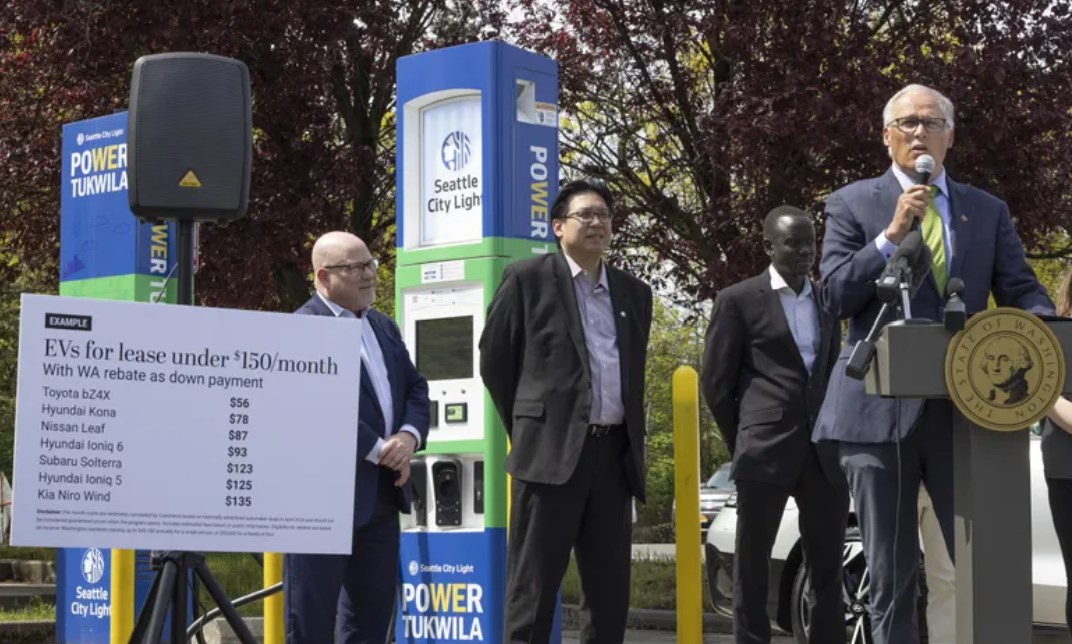 Washington Gov. Jay Inslee announces a new state rebate program that will make electric vehicles more affordable for lower-income residents at a media event at a Seattle City Light public charging station in Tukwila on... (Ellen M. Banner / The Seattle Times)