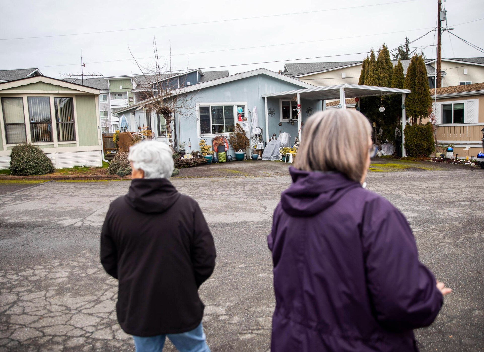 Royalwood Estates Mobile Home Park residents Patsy Gilbert, left, and Elna Olson, right, give a brief tour of the mobile home park on Monday, March 11, 2024 in Lynnwood, Washington. 