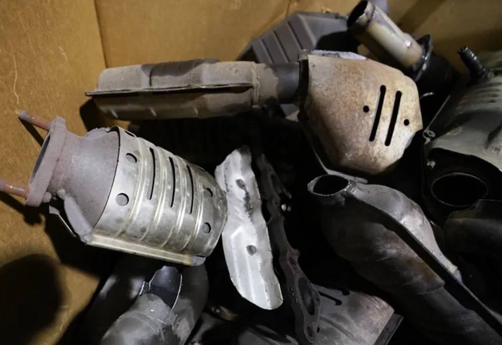 Catalytic converters that were removed from cars are piled in a salvage yard in Richmond, Va. In Washington, a new law aims to stamp out the black market of illicit buyers.