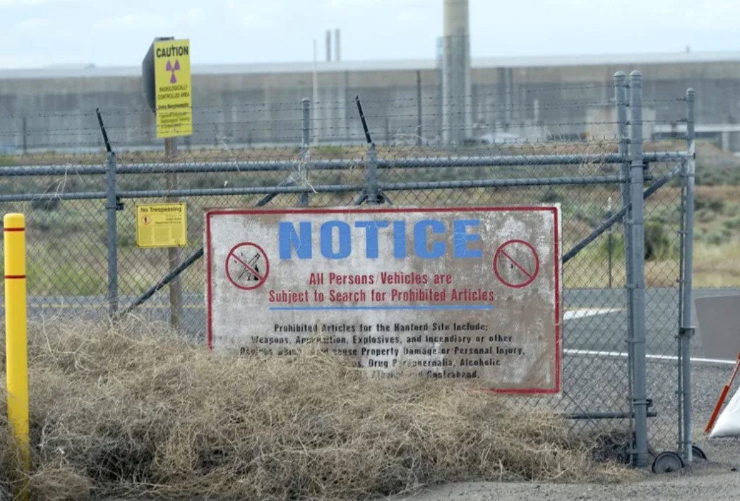 Caution signs are shown at a gate on the Hanford Nuclear Reservation, Thursday, June 2, 2022, during a tour of the facility in Richland, Wash. (Ted S. Warren / AP)