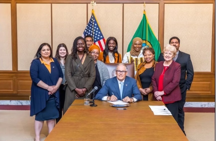 Washington state Gov. Jay Inslee and supporters of Senate Bill 5453 against female genital mutilation at the bill's signing in 2023.