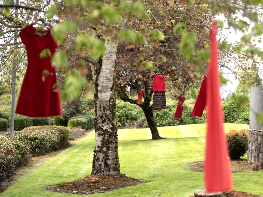 Red dresses representing murdered and missing Indigenous women hang from trees outside the Cowlitz Indian Tribe Health & Human Services office in Hazel Dell on May 3. May is Missing and Murdered Indigenous People Awareness Month. (Photos by Taylor Balkom/The Columbian)