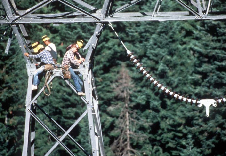 A crew builds transmission lines. A new report says that 30% more electricity will be needed in the coming decade in the Northwest.