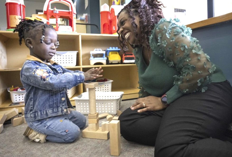 Zaneta Billyzone-Jatta smiles at her two-year-old daughter, Zakiah Jatta, in her classroom at Akin’s Early Learning Center on March 26 in Auburn. Zakiah is enrolled in Washington’s ECEAP (Early Childhood Education and Assistance Program). (ellen m. banner/The Seattle Times)