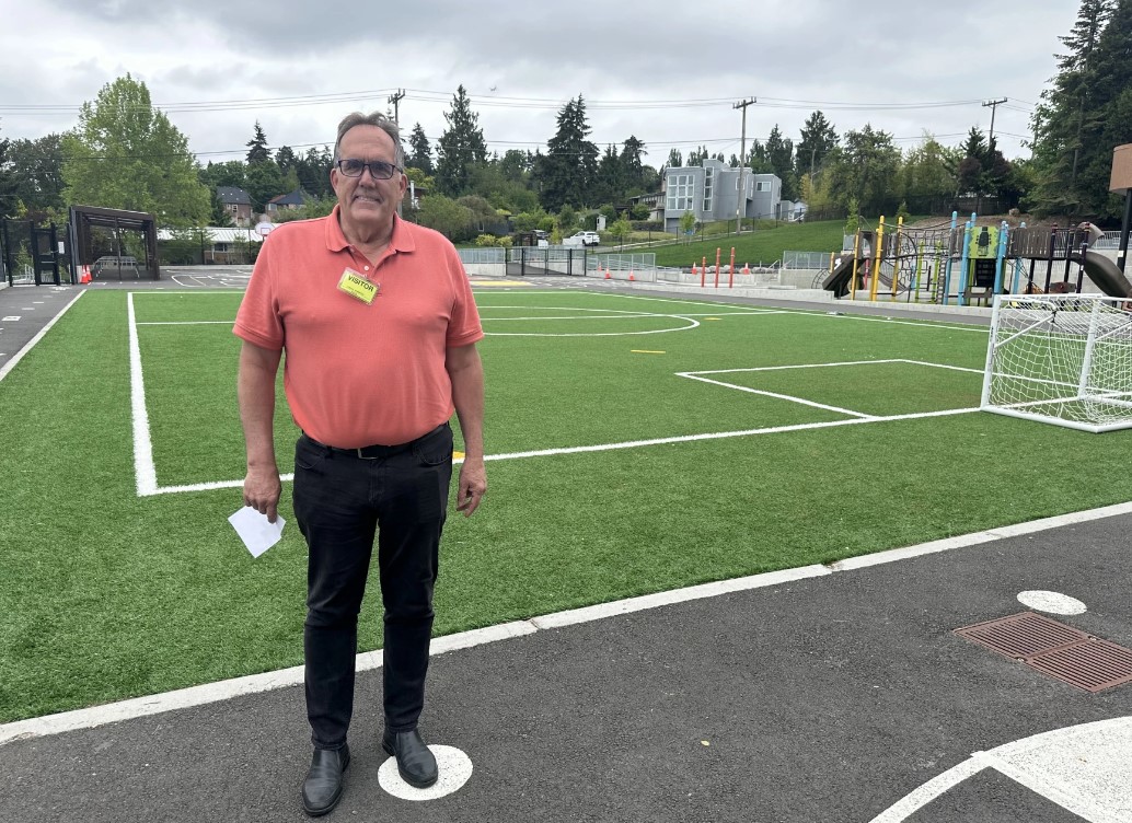 Richard Best from Seattle Public Schools shows off a new ballfield at Kimball Elementary. Beneath the turf are geothermal wells that are used to heat and cool the building, similar to how a home heat pump works. The district started using geothermal H-VAC systems in 2006. Now, nearly a third of its buildings use them.