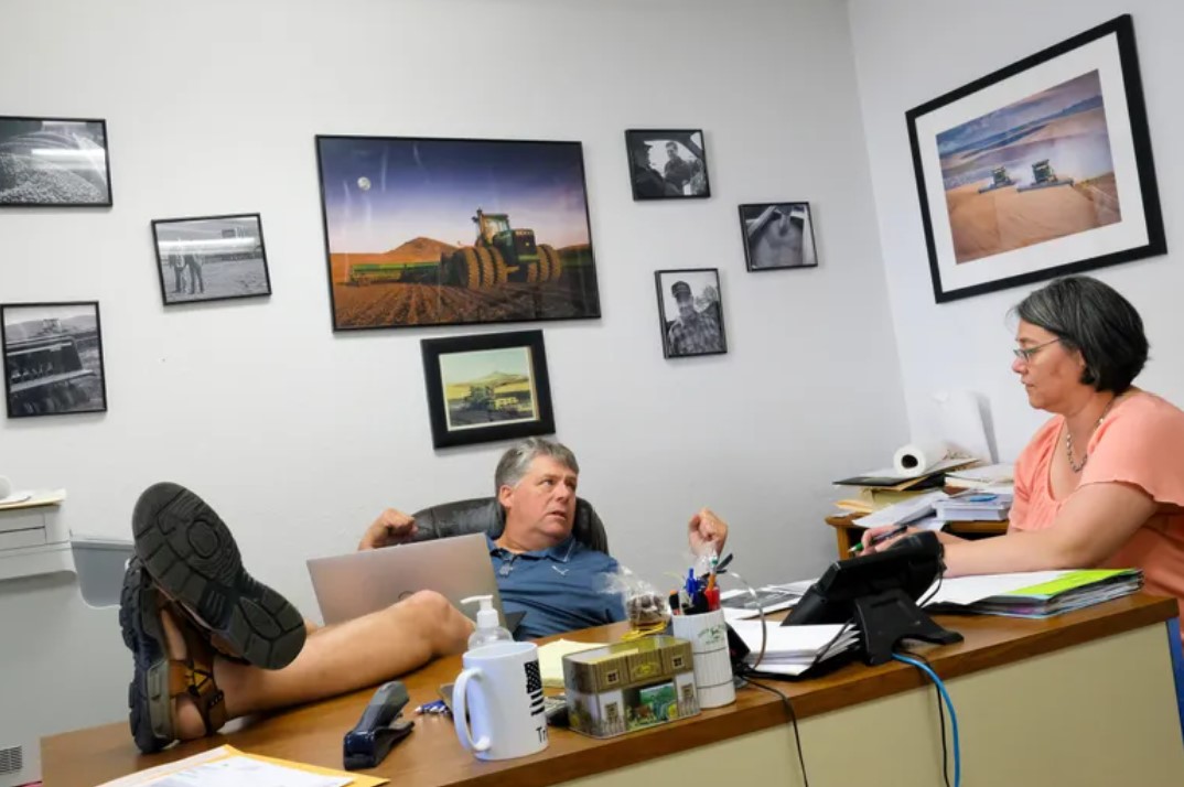 Attorney Rusty McGuire of the law firm McGuire, DeWulf, Kragt & Johnson goes over legal issues with Shani Hergert, the clerk for the town of St. John, on June 13 at his office in St. John. (Tyler Tjomsland / The Spokesman-Review)