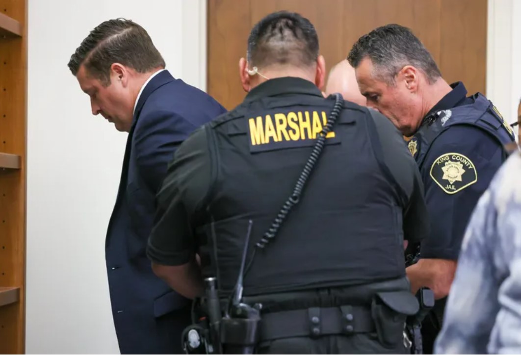 Auburn police Officer Jeffrey Nelson is taken into custody after a jury in Kent convicted him Thursday of second-degree murder and first-degree assault in the 2019 shooting death of Jesse Sarey. (Kevin Clark / The Seattle Times)