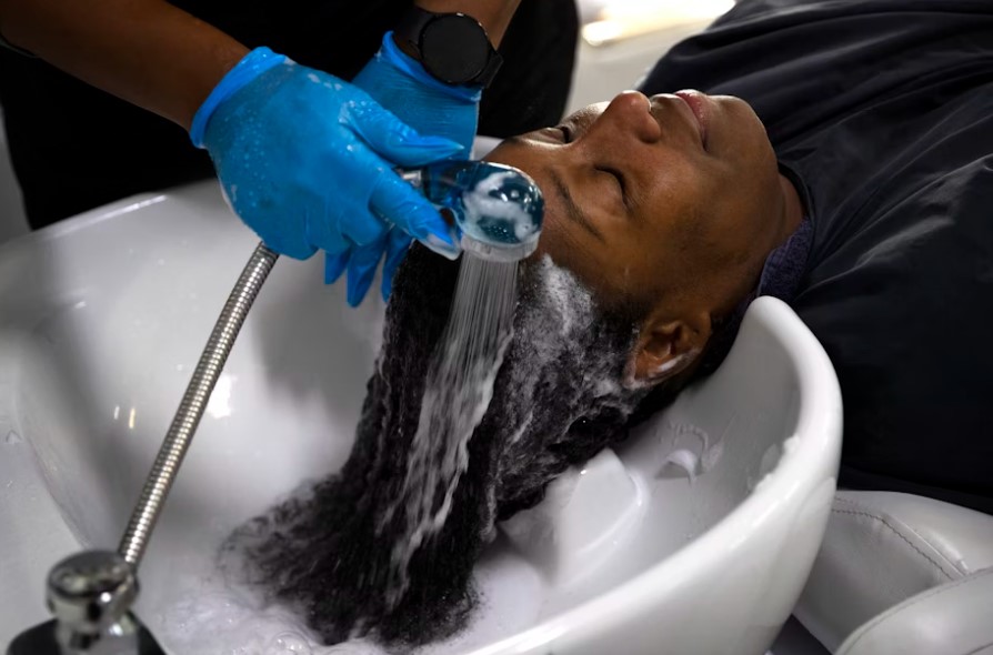 Nina Trapp washes DaVonna Johnson’s hair during an appointment at Mati’s Salon and Barbershop on Friday, May 24, 2024, along Rainier Avenue South in Seattle.