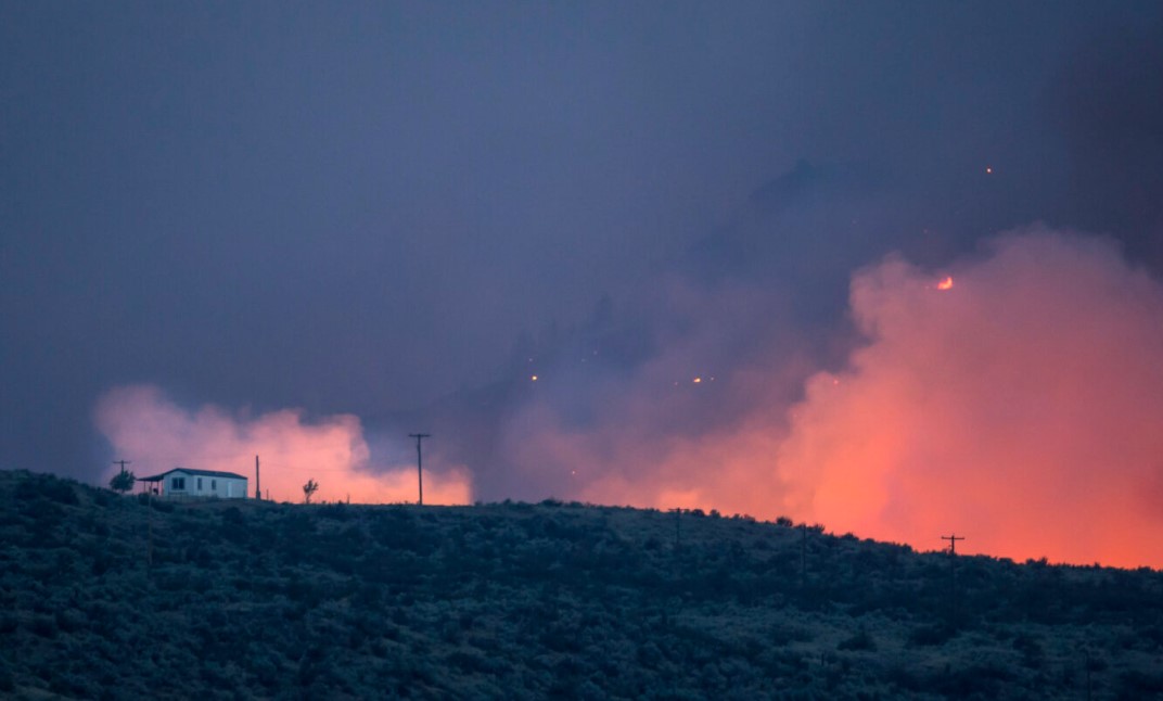 Part of the Okanogan wildfire complex flares up on August 21, 2015 in the hills near Omak. The fires, which killed three firefighters and critically injured another, threatened homes and communities throughout the area. (Photo by Stephen Brashear/Getty Images)