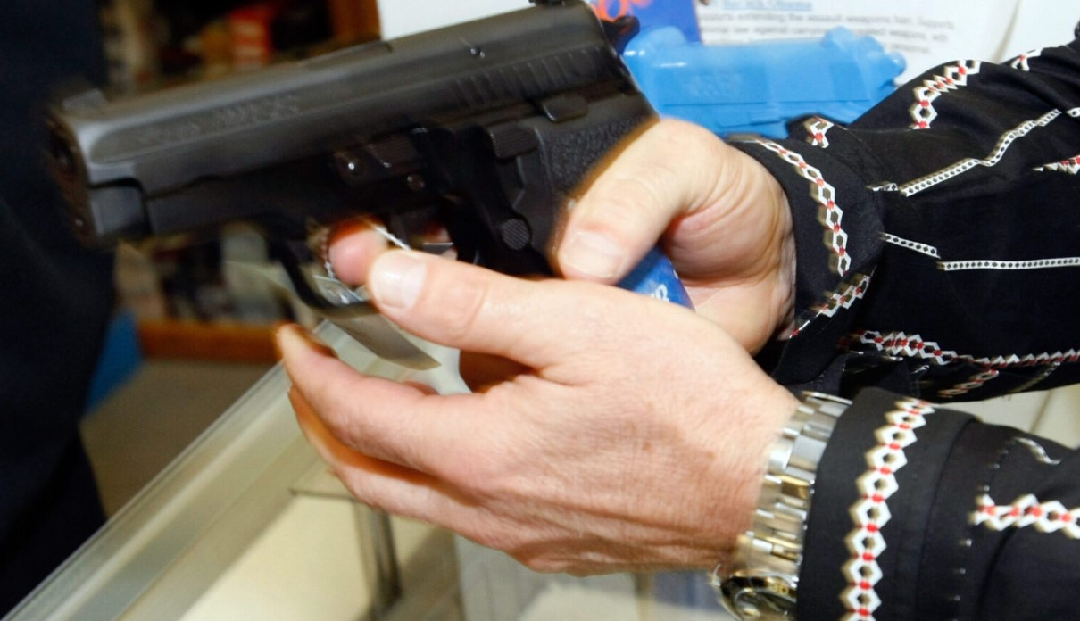 A customer tries out a semi-automatic pistol at The Gun Store on Nov. 14, 2008 in Las Vegas, Nevada. (Photo by Ethan Miller/Getty Images)