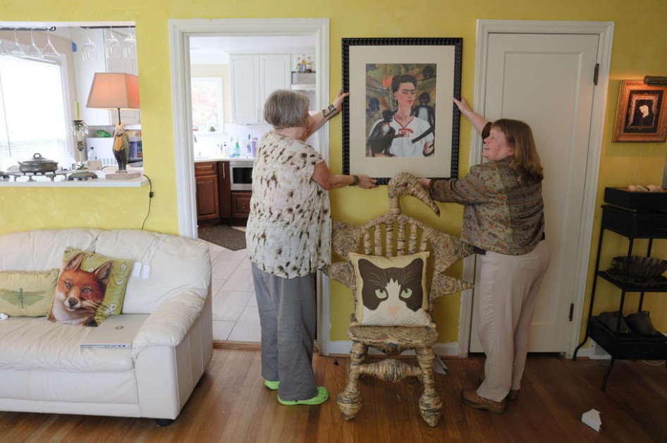 Maryann Griffin and Sandra Mears discuss where to hang a print of Frida Kahlo’s “Self-Portrait with Monkeys” in their new home, May 29, 2024. (Genna Martin/Cascade PBS)