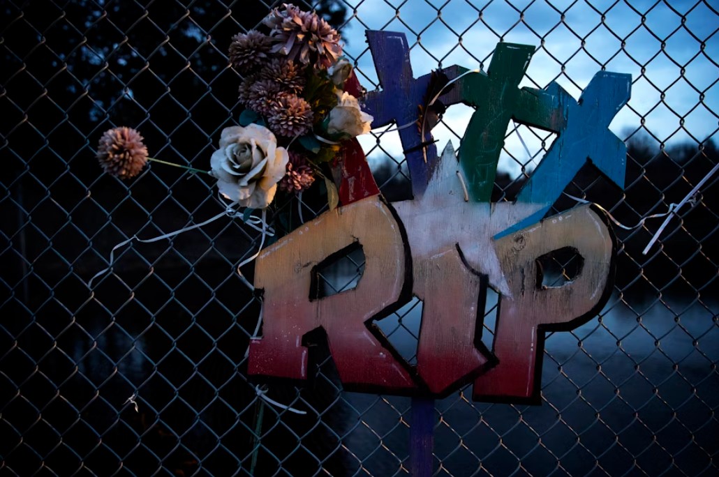 A memorial with three crosses hangs on a chain-link fence along Totem Beach Road on the Tulalip Reservation on March 8, 2023.