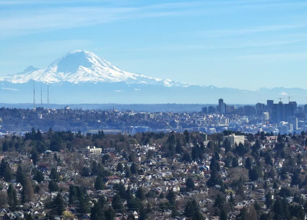 Mount Rainier seen from over the Crown Hill neighborhood during a warm and sunny afternoon in Seattle in March. A new program offers homebuying assistance to Washingtonians who faced housing discrimination in the early 20th... (Karen Ducey / The Seattle Times)