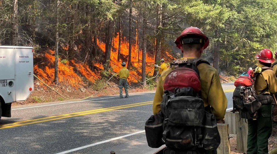 Firefighters douse flames along state Highway 20 near Newhalem, Wash., on Monday, Aug. 14, 2023. WASHINGTON STATE DEPARTMENT OF TRANSPORTATION Courtesy to The Bellingham Herald