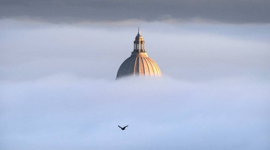 The Washington State Capitol pops out of the thick fog on a freezing morning as seen from Overlook Park in Tumwater, Washington, on Friday, Nov. 24, 2023. TONY OVERMAN toverman@theolympian.com