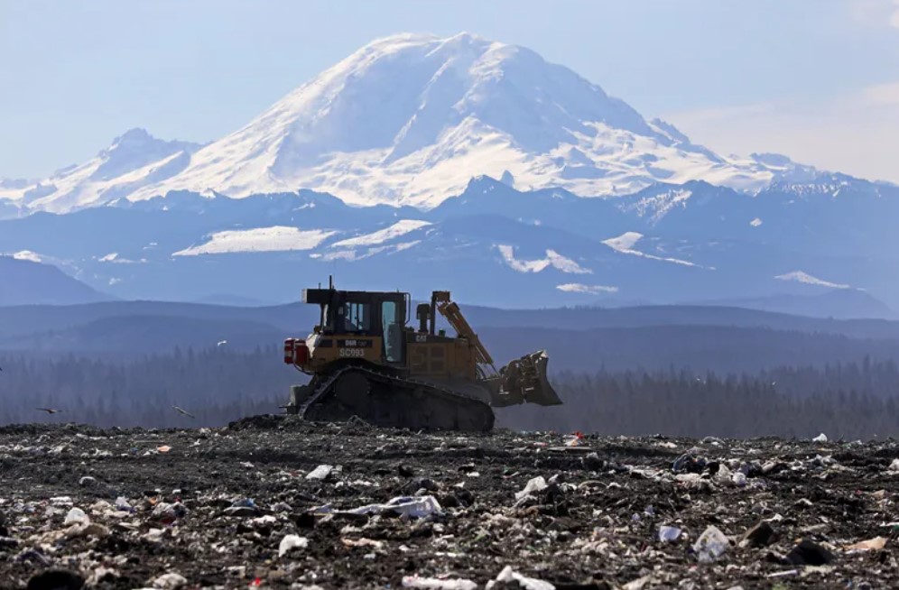 A bulldozer compacts trash at Cedar Hills Regional Landfill near Maple Valley. New rules intended to keep a tighter lid on methane gas leaking from the state’s landfills as food and garbage... (Ken Lambert / The Seattle Times, 2019)