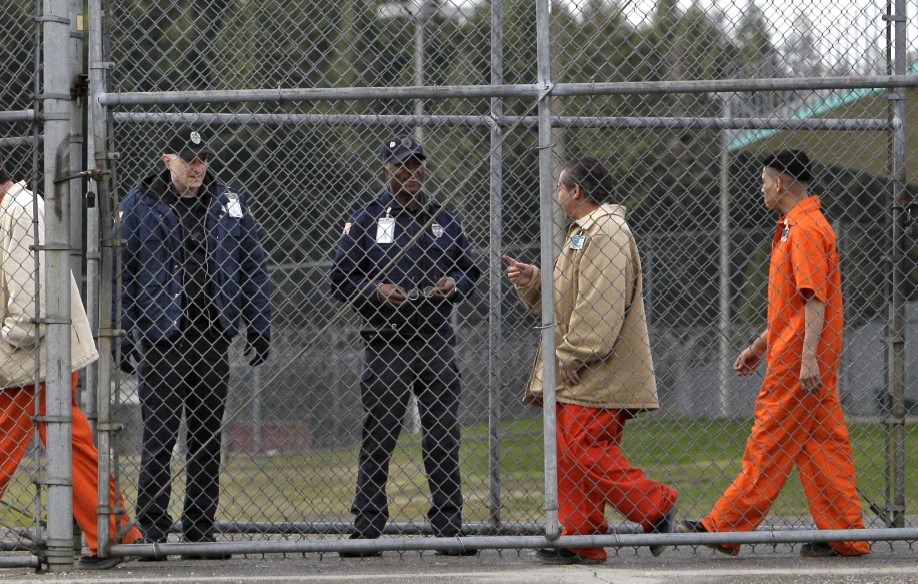 In this Feb. 17, 2011 file photo, inmates walk past correctional officers at the Washington Corrections Center in Shelton, Wash.