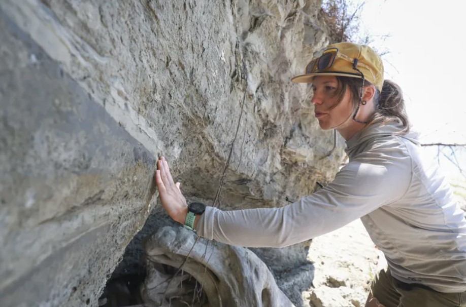 Keeley Chiasson, who is a coastal geomorphologist grad student and geologist in training, observes patterns on a bluff in Tulalip on Wednesday, August 7, 2024. (Ivy Ceballo / The Seattle Times)