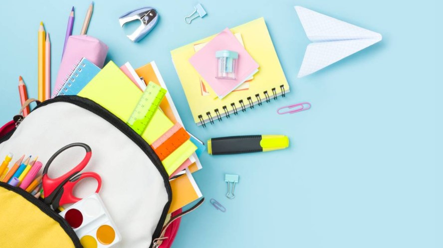 Many colorful school supplies and backpack arranged on blue background DIDECS Getty Images/iStockphoto