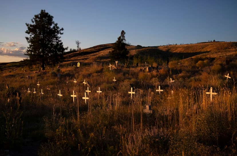 Unmarked graves are shown behind St. Mary’s Catholic Mission on Thursday, July 20, 2017, in Omak.