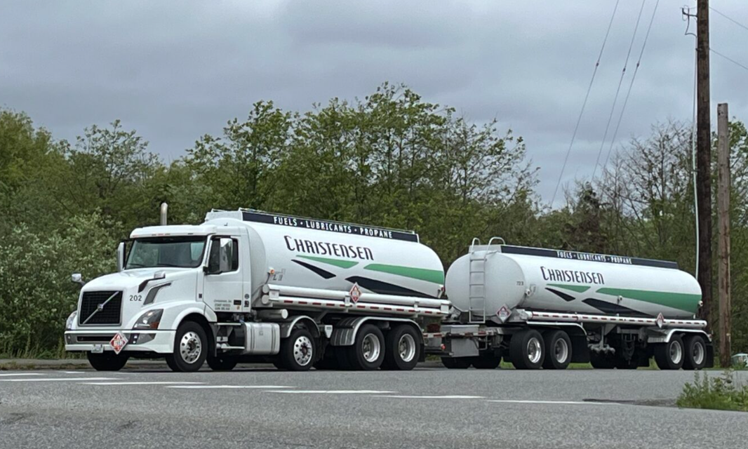 A Christensen fuel truck leaves a refinery in Anacortes. Christensen, a major agricultural fuel distributor, was among the first to offer exemptions under the Climate Commitment Act. (Bill Lucia/Washington State Standard)