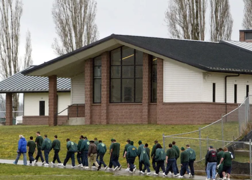 In 2009, juveniles at Green Hill School walk across campus with supervisors at both the front and back of the lines. (Thomas James Hurst / The Seattle Times)