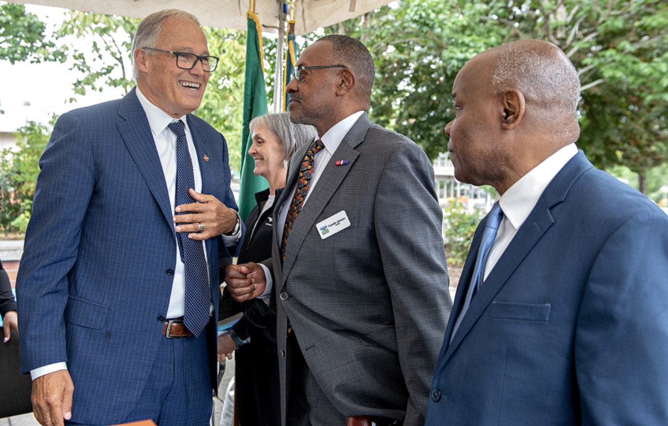 Gov. Jay Inslee, from left, talks with Smart Communities Awards recipients Cassi Marshall of the Port of Camas-Washougal, Franklin Johnson of the Commission on Aging and Oliver Orjiako of Clark County Community Planning outside the Clark County Public Service Center on Thursday afternoon. (Amanda Cowan/The Columbian)