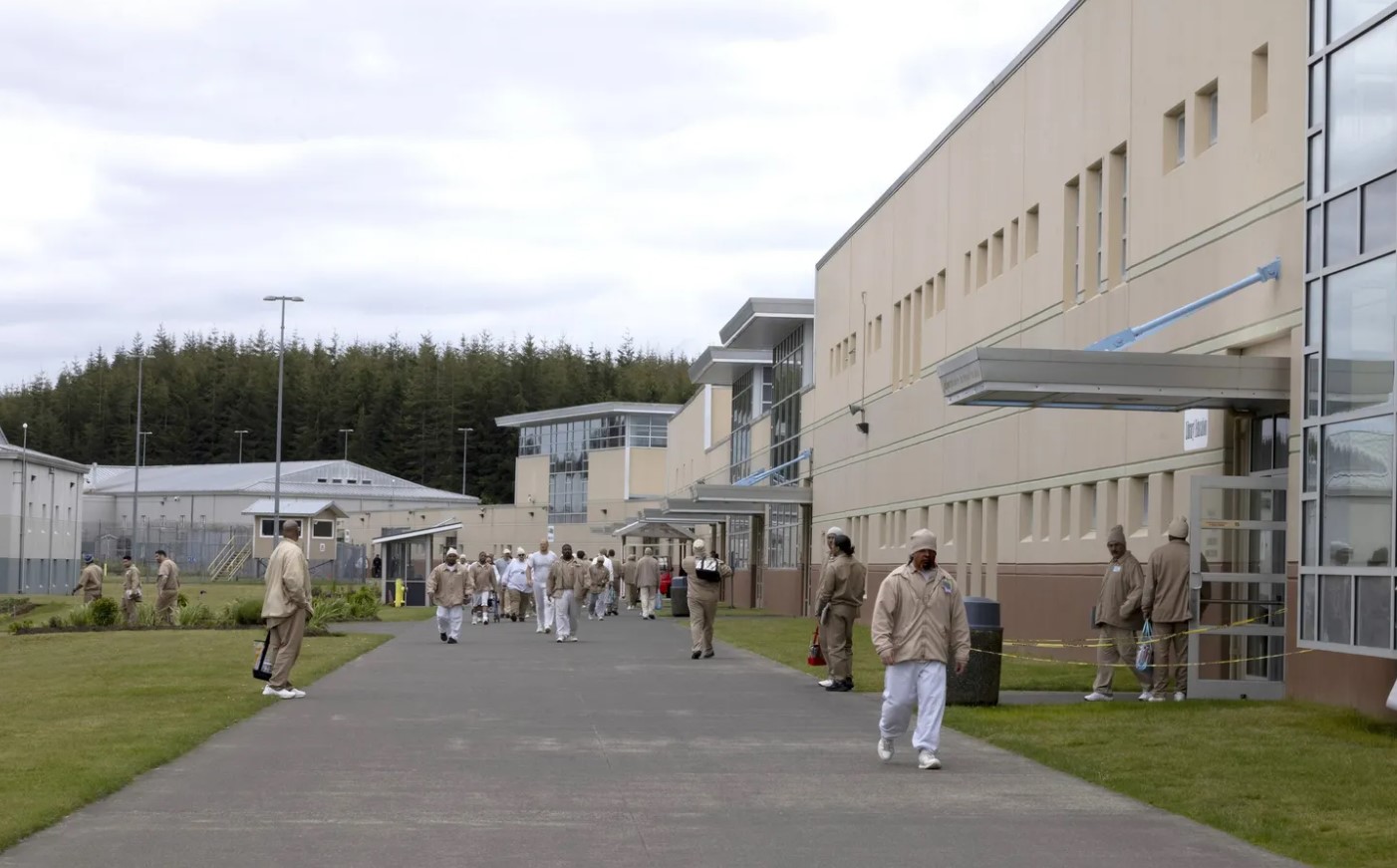 Incarcerated people walk the grounds at Stafford Creek Corrections Center. (Ellen M. Banner / The Seattle Times)