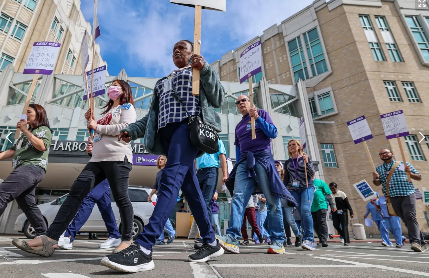 Unionized public service workers march around Harborview Medical Center in Seattle on Tuesday afternoon. (Kevin Clark / The Seattle Times)