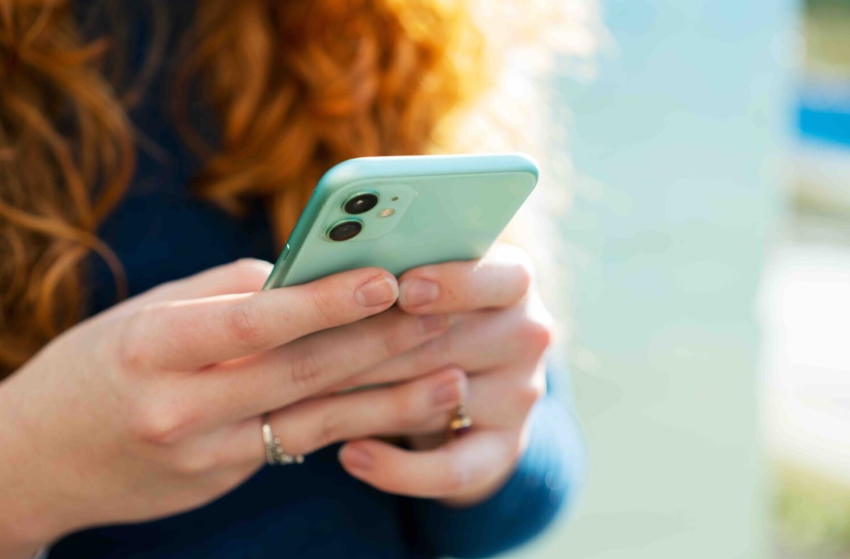 A student holds their phone in their hands