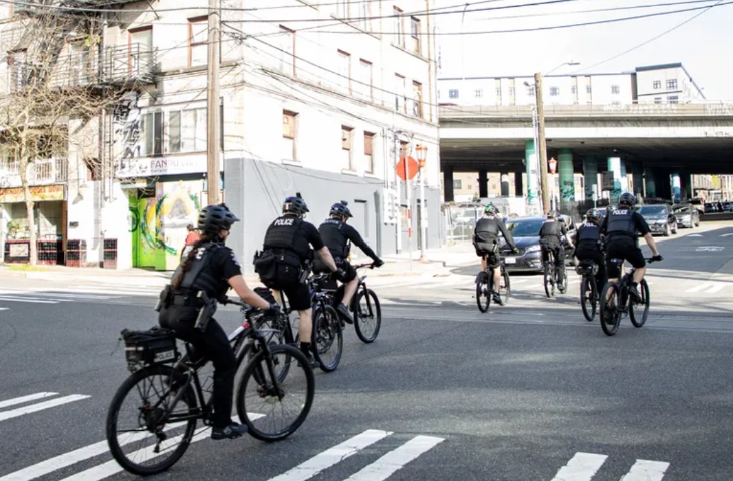 Seattle Police Department officers ride up King Street to 12th Avenue. New court filings indicate that the department could be close to being released from federal oversight. (Luke Johnson / The Seattle Times, 2023)