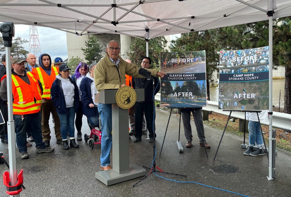 Gov. Jay Inslee points to the work his homeless encampment initiative has done to clear encampments and transition people into housing. Last December, Inslee released his budget proposals surrounding housing and homelessness programs at the site of a former encampment in Seattle. (Laurel Demkovich/Washington State Standard)