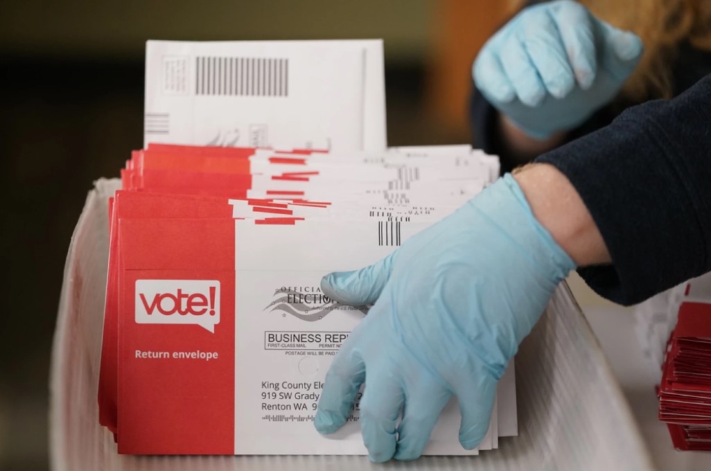 Erik Thurston prepares ballots from a drop box for the sorting machines on Election Day at the King County Elections headquarters, Nov. 7, 2023, in Renton, Wash.