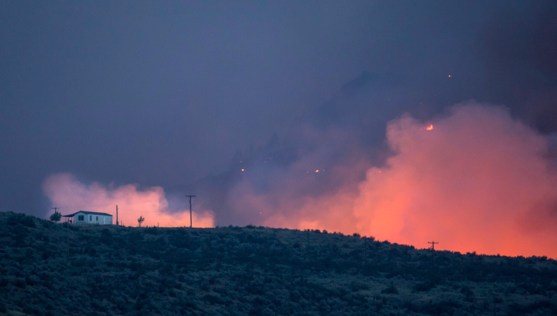 Part of the Okanogan wildfire complex flares up on August 21, 2015 in the hills near Omak. The fires, which killed three firefighters and critically injured another, threatened homes and communities throughout the area. (Photo by Stephen Brashear/Getty Images)