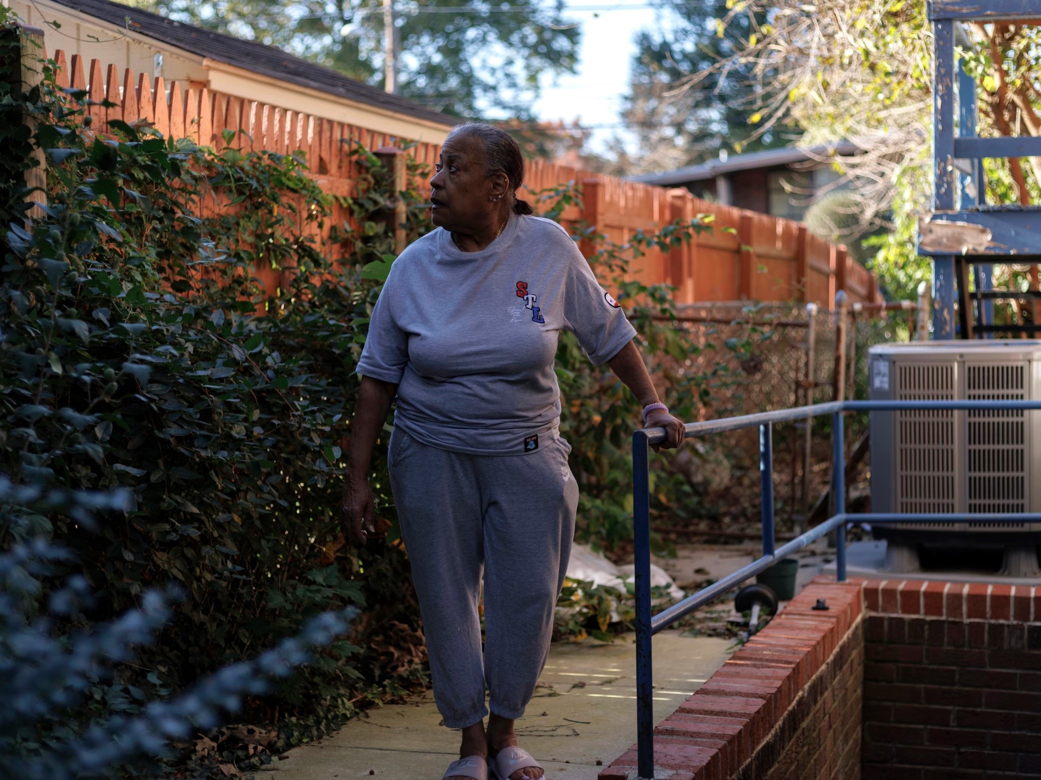 Pat Haskins, a 72-year-old retired school teacher, poses for a portrait in the backyard of her home in Silver Spring, Md., on Oct. 22. She had struggled to keep up with repairs as her basement flooded, a bathroom floor sagged and her disabled partner needed a ramp.