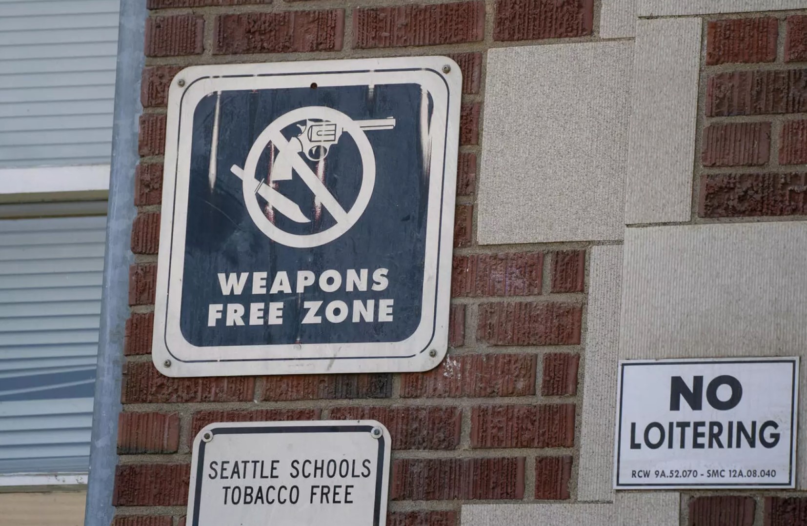 A “Weapons Free Zone” sign is seen at Garfield High School in Seattle, Washington on June 8, 2024.