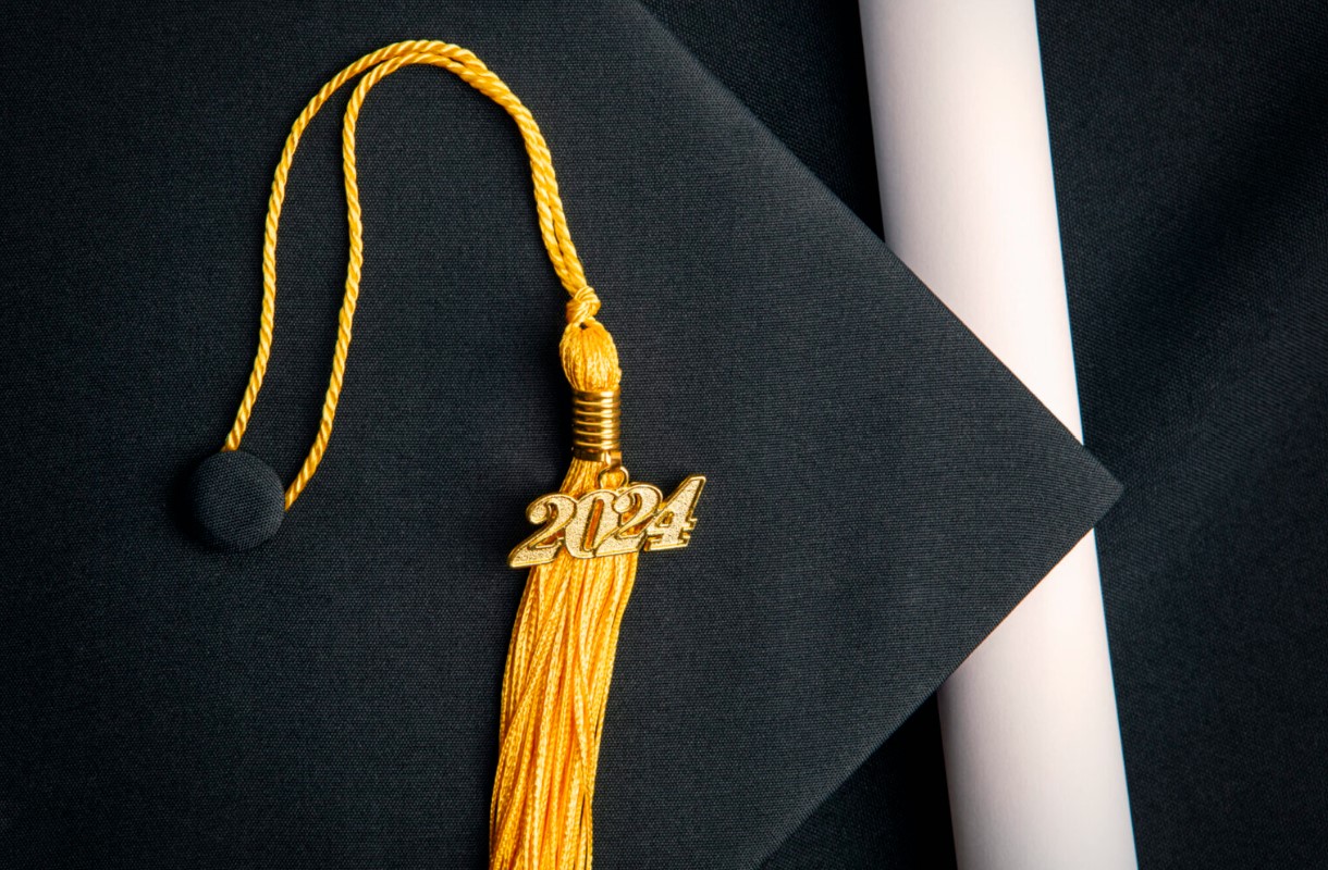 Close up of a graduation cap with a yellow 2024 tassel.