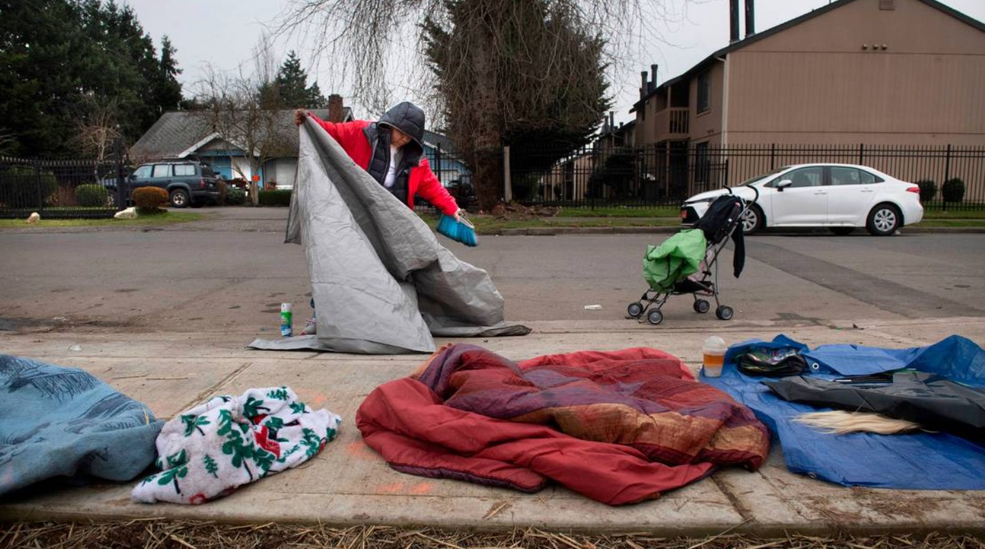 Lethecia Lee packs up her tent and belongings in anticipation of a forced move from the homeless encampment where she stayed for three months on I Street and East 72nd Avenue in southeast Tacoma on Wednesday, Jan. 26, 2022. TONY OVERMAN toverman@theolympian.com