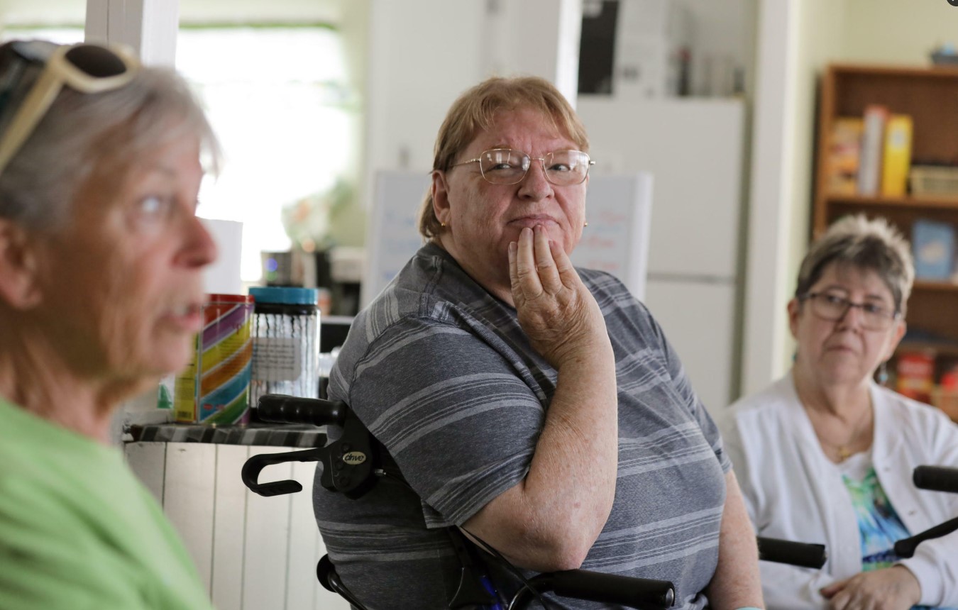 Members of the tenants' organization at Leisure Manor Estates in Aberdeen (Judie Short, left; Deb Wilson, center; and Caroline Hardy) met in the community clubhouse in 2023 to discuss Hurst & Sons LLC policy changes and rent increases. (Genna Martin/Cascade PBS)