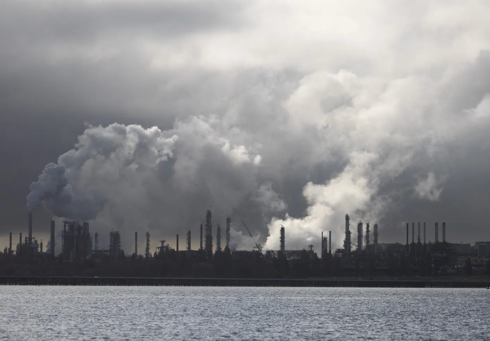 The Marathon oil refinery in Anacortes is seen in September. The state’s Climate Commitment Act requires the state’s most polluting businesses to reduce their emissions or purchase allowances to cover them. (Nick Wagner / The Seattle Times)