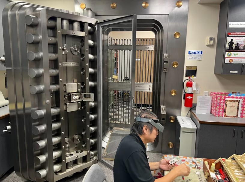 The state vault door in Olympia's capitol building undergoing maintenance by Patrick Luong, a technician.