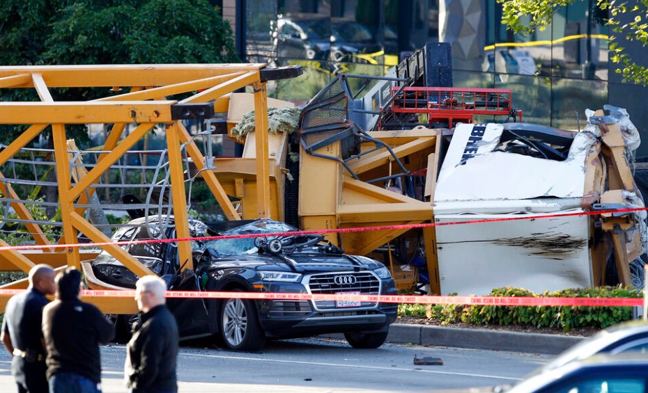 In this April 27, 2019, file photo, emergency crews work at the scene of a construction crane collapse where four people were killed and others injured in Seattle’s South Lake Union neighborhood. Starting in 2025, companies are required to go through a permitting process and close streets to operate cranes in the state. (AP Photo/Joe Nicholson)