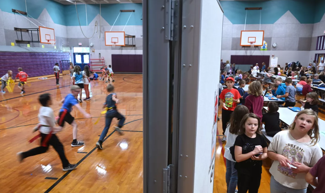 A physical education class takes place in September at Arcadia Elementary in Deer Park while students file in for lunch. The gymnasium is divided by a modular wall to make room for a cafeteria-style space in the school, which is dealing with an explosion in student population. (Jesse Tinsley/The Spokesman-Review)