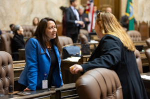 Rep. Davina Duerr speaking with Rep. Alicia Rule on the House floor