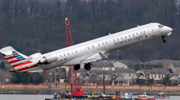 Salvage crews work on recovering wreckage of a mid-air collision between a passenger jet and a military helicopter, Feb. 6, 2025, in Arlington, Va.Credit: (AP Photo/Jose Luis Magana)