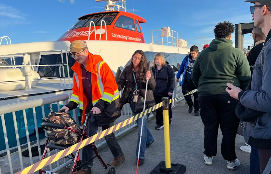 Passengers disembarking from one of Kitsap Transit's passenger-only ferries while others wait to embark in February 2024. KUOW Photo/Joshua McNichols