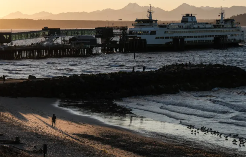 A person walks along the beach late in the day as the sun illuminates Brackett’s Landing in Edmonds last month. Some new market research data shows in the Seattle area, there is a remarkably high use of antidepressants and antianxiety medication among young women. (Dean Rutz / The Seattle Times)