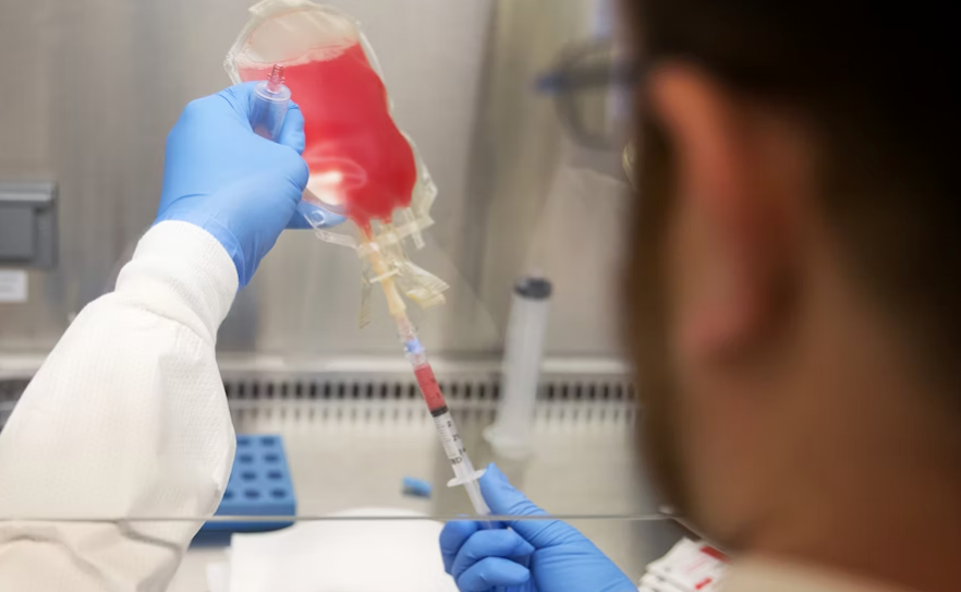 Cell technologist Ian Townsend thaws T-cells for infusion in the Swim Across America Cellular Therapy Lab on Wednesday, October 25, 2017, at the Fred Hutch Eastlake Building in Seattle. KUOW Photo/Megan Farmer