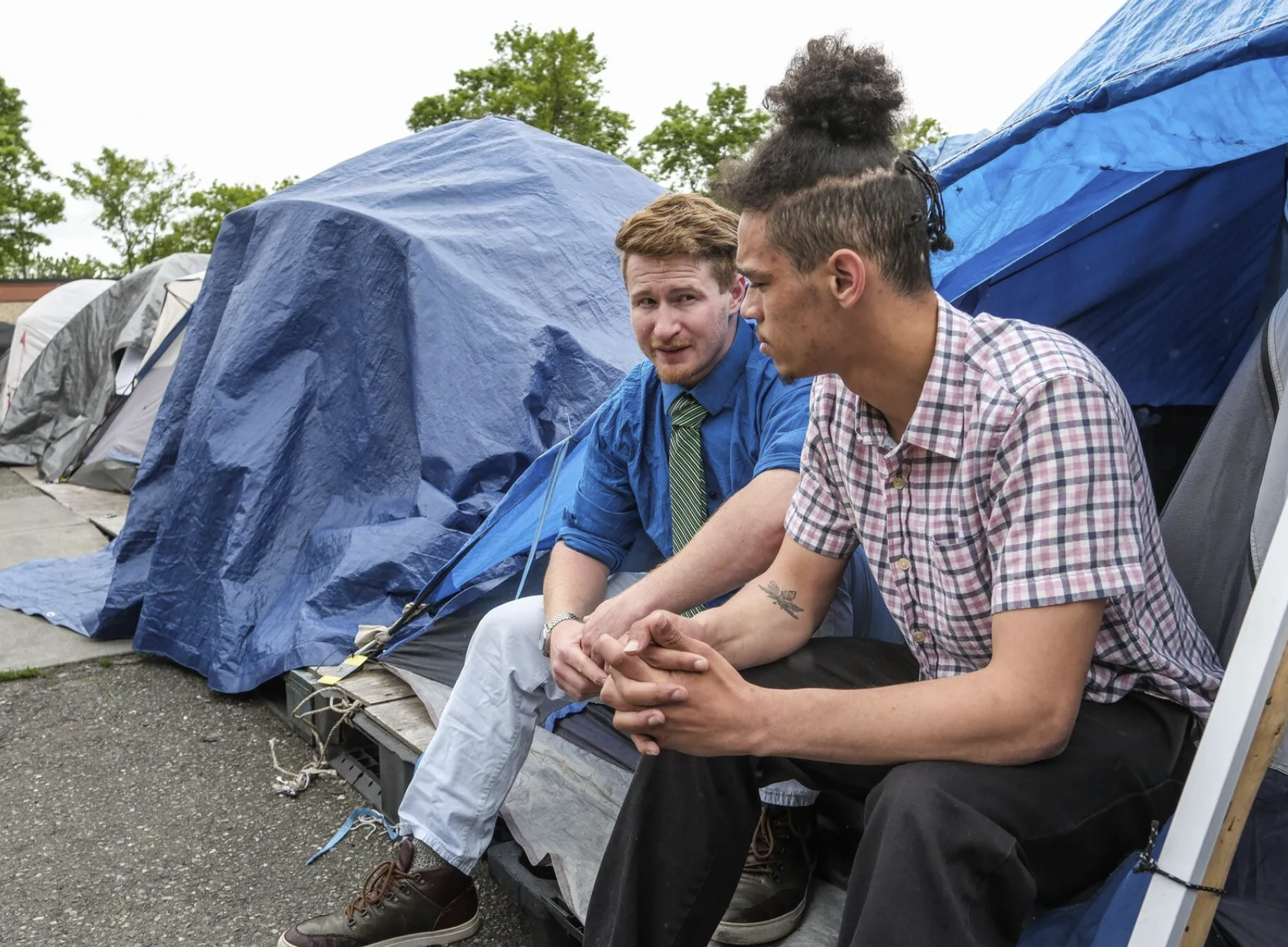 Justin Fain, left, and A.V. Royal are residents of Tent City 4, and subject to moving this weekend when the lease is up at their current location in Lake City. (Dean Rutz / The Seattle Times)
